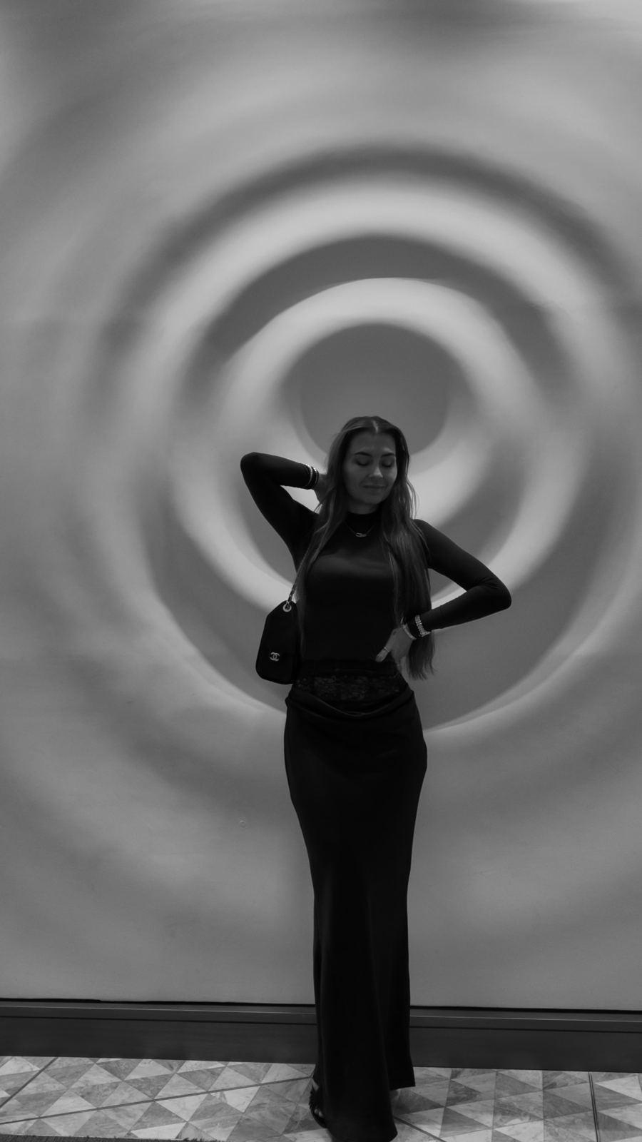 Dzanella standing in front of a spiral wall